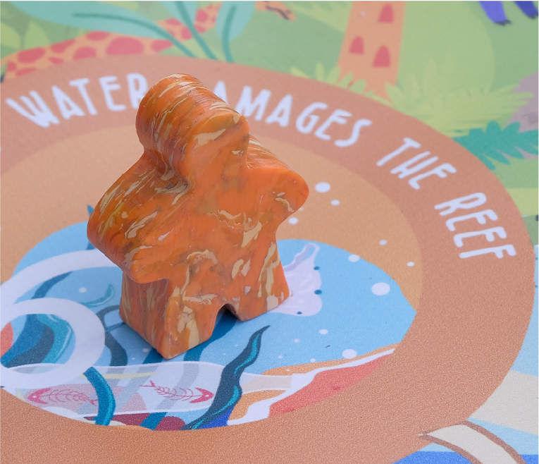 A human-like figurine on top of a board educational game